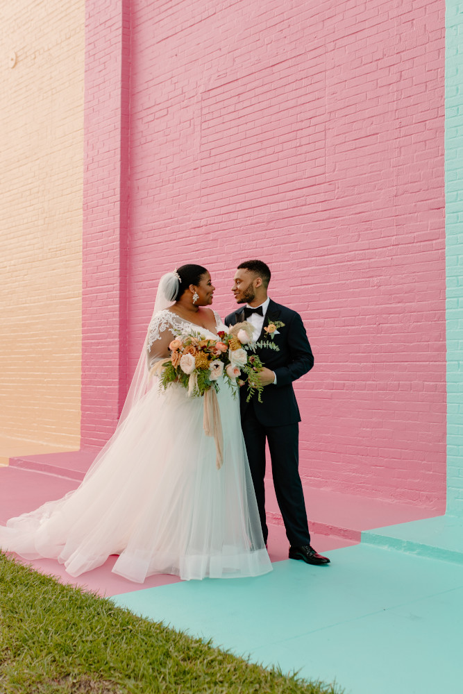 Bride and groom in front of Color Wall at Haus 820 in Lakeland, FL
