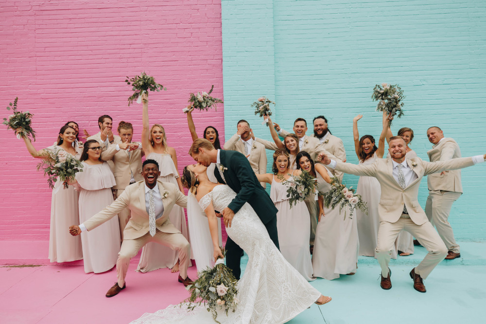 Entire wedding party in front of Color Wall at Haus 820 in Lakeland, FL